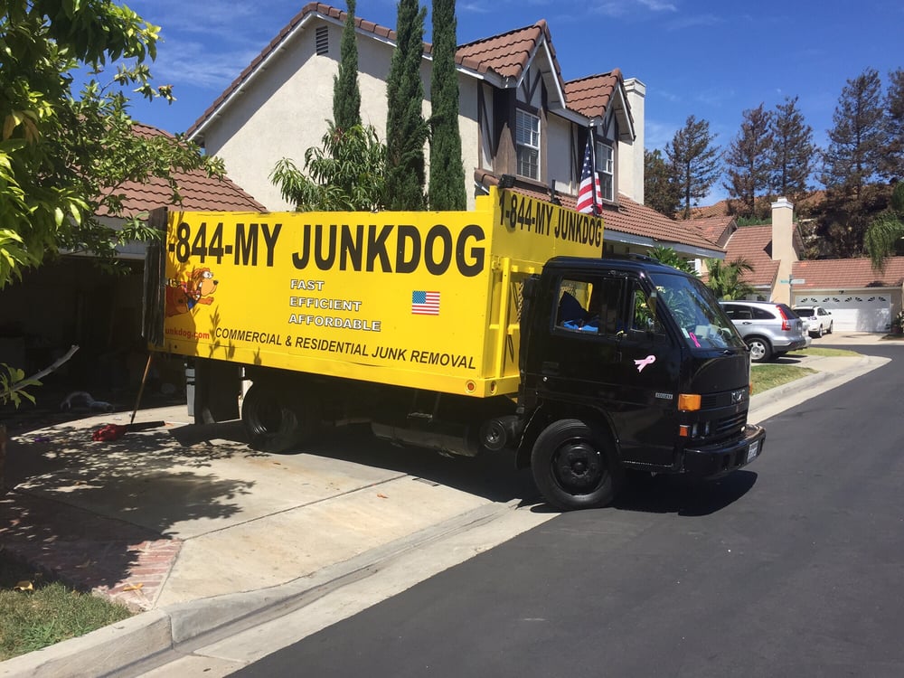 My Junk Dog truck at a home providing Orange County Junk Removal services